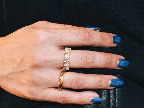 Woman's hand wearing Lisa Gold Crystal Ring  and wave ring