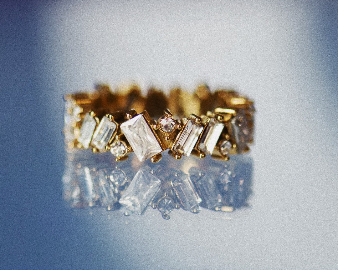 Lisa Gold Crystal Ring on blue background