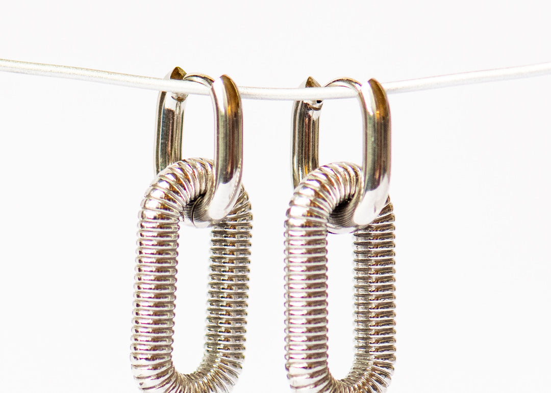 Close up of Link_Drop_Hoop_Silver_Earring white background