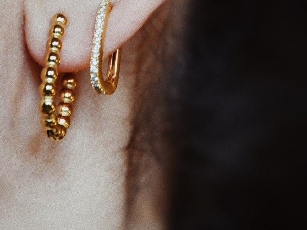 woman wearing the Ciara Hoop Earrings, layered, stylish, gold plated, waterproof, non-tarnishing