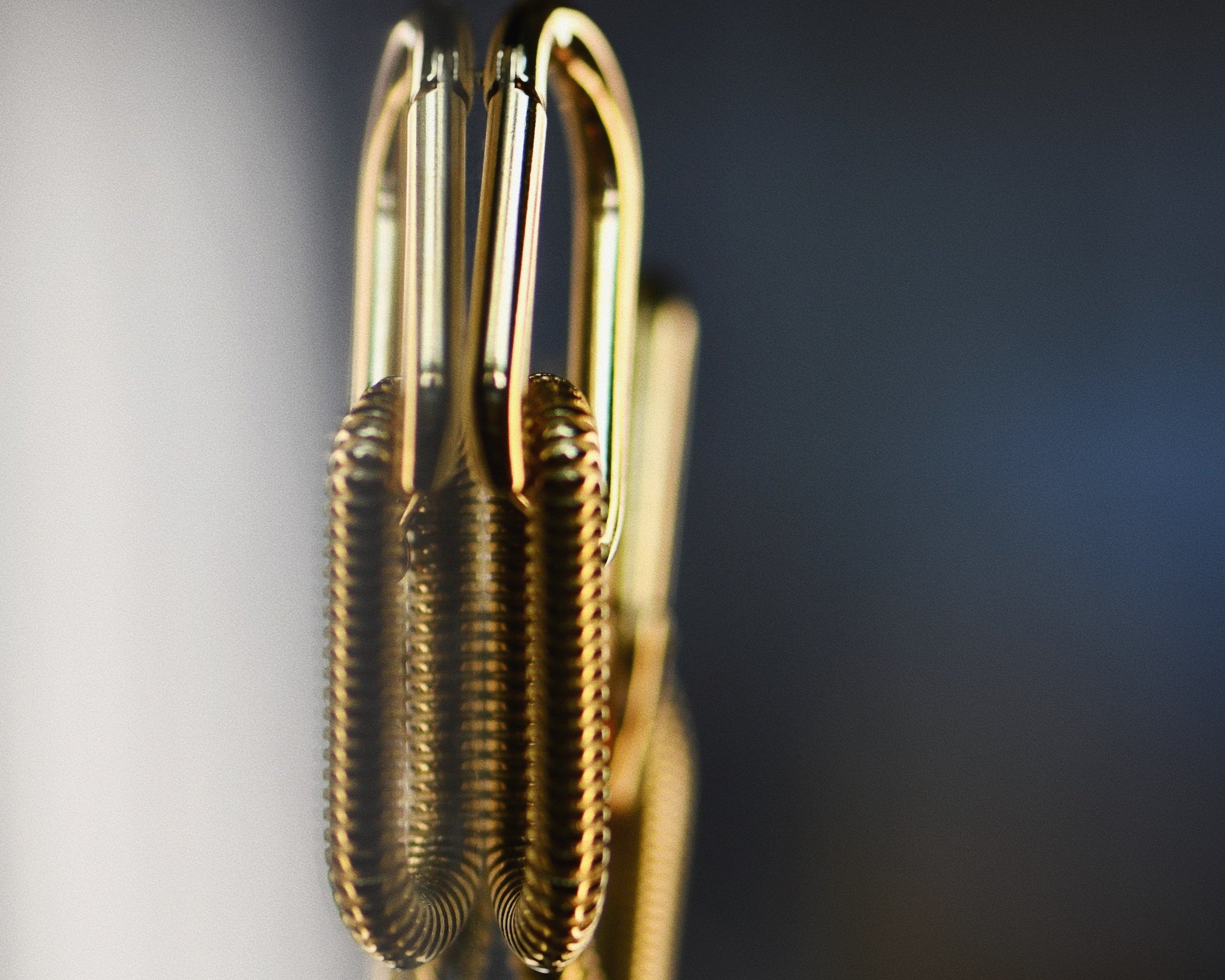 Artistic image of the Link Hoop Drop Gold Earrings