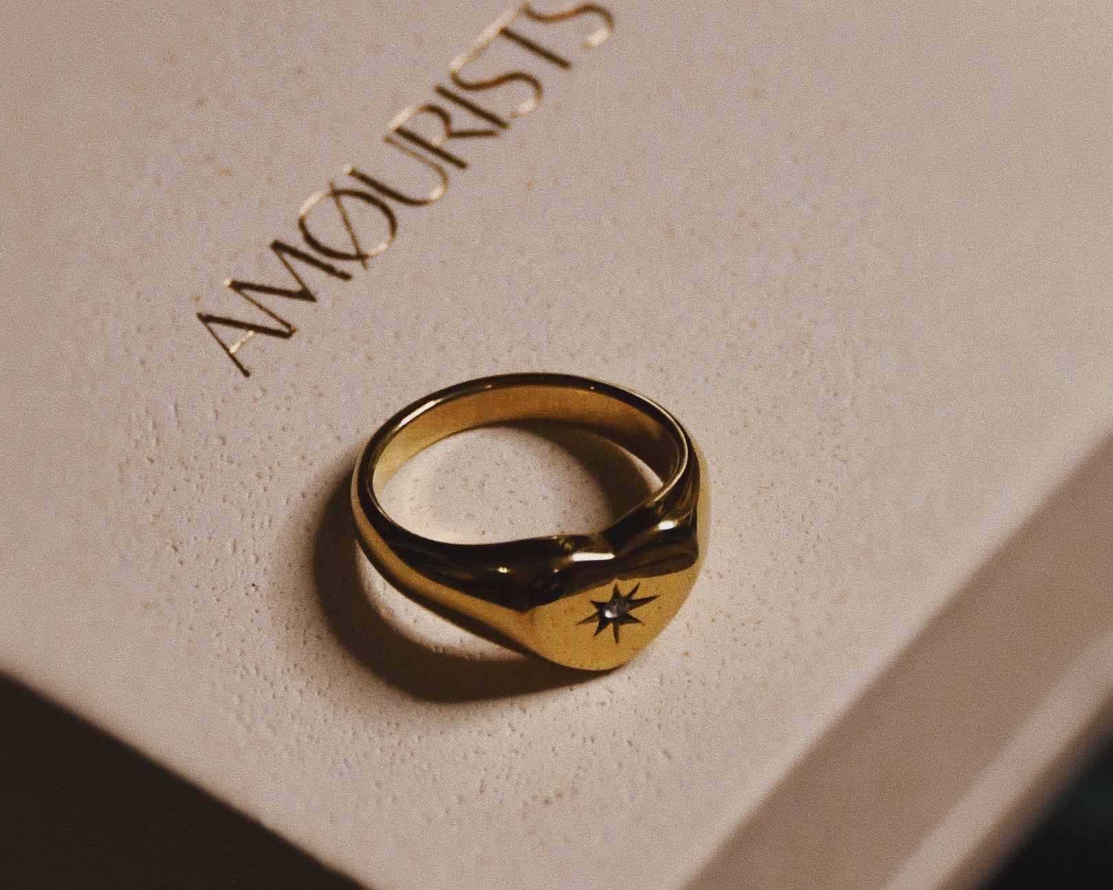 Lovestruck Gold Ring on top of the beautiful packaging