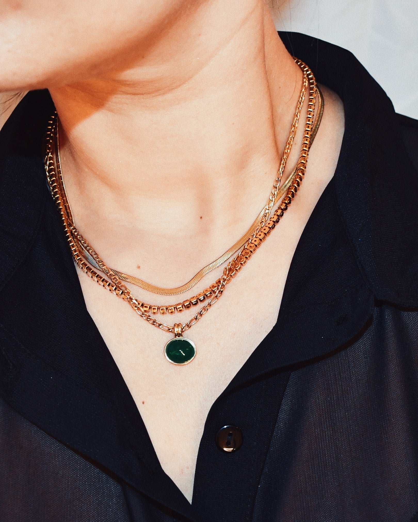 Stylish photography of woman Serpentine Chain Necklace layered with other necklaces