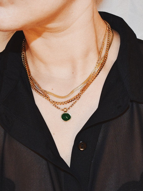 Stylish woman wearing Maya Green Pendant Charm Chain Necklace layered with other necklaces