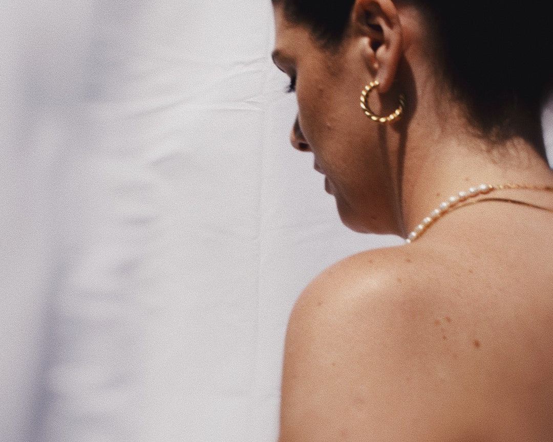 Woman wearing the Vivienne Gold Hoop Earrings