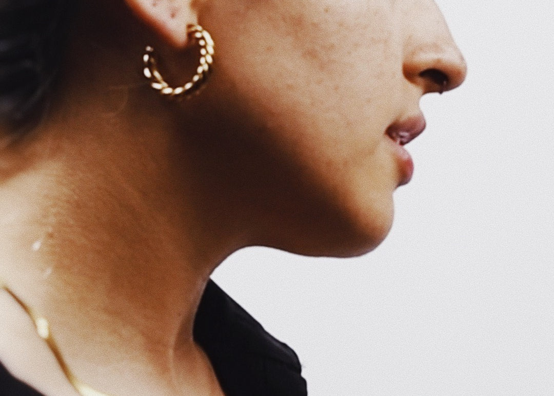 Woman wearings Vivienne Gold Hoop Earrings