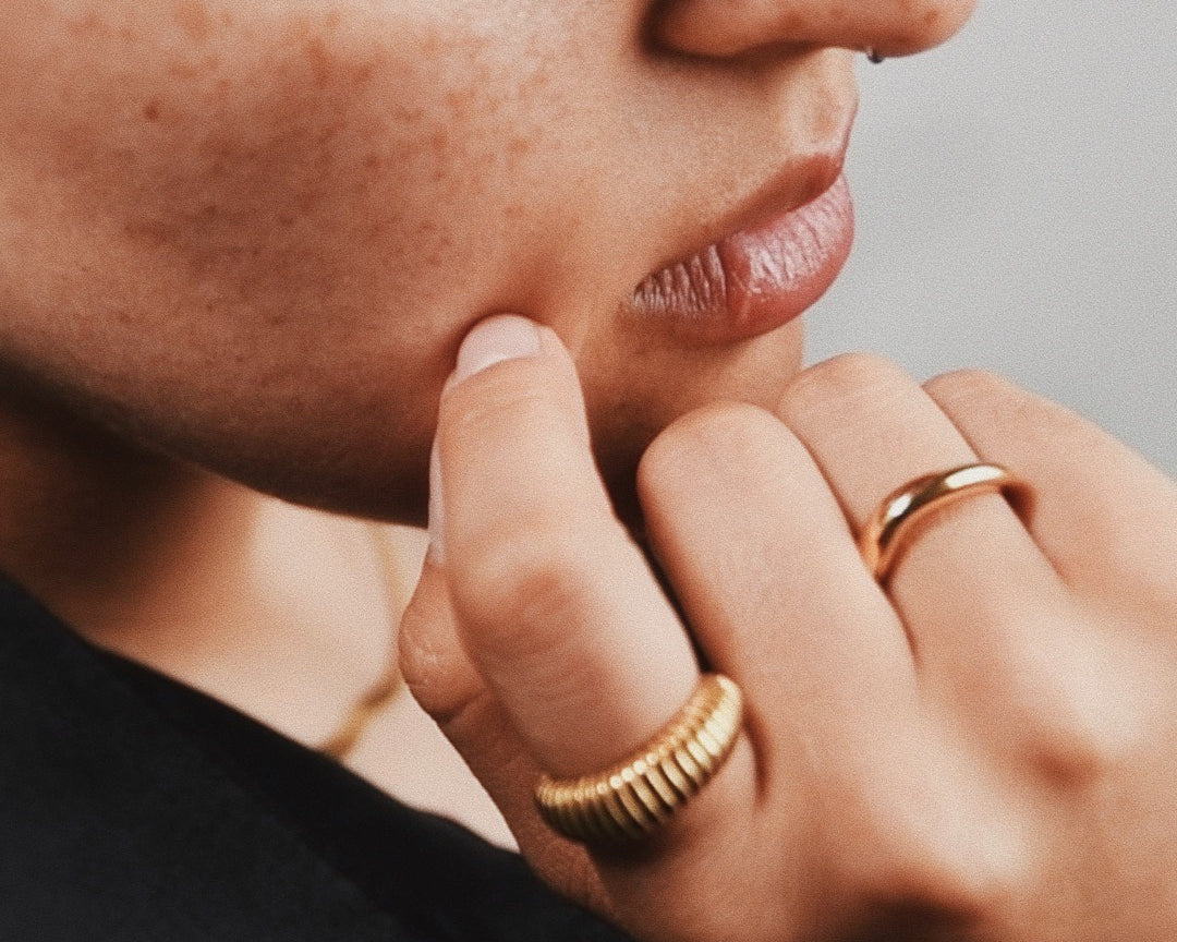 Woman wearing Gilded Gridwork Gold Ring and Maris Gold Ring