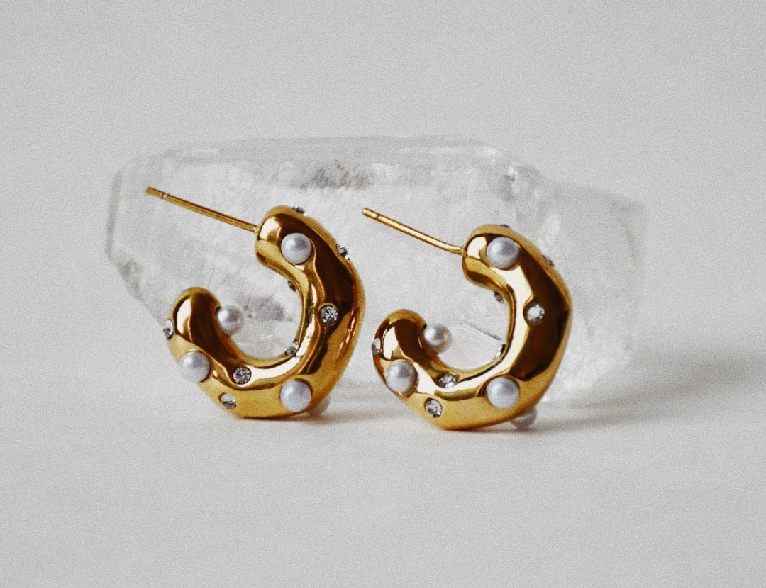 Stylised Emily Small Hoop Gold Earrings with white quartz in the background