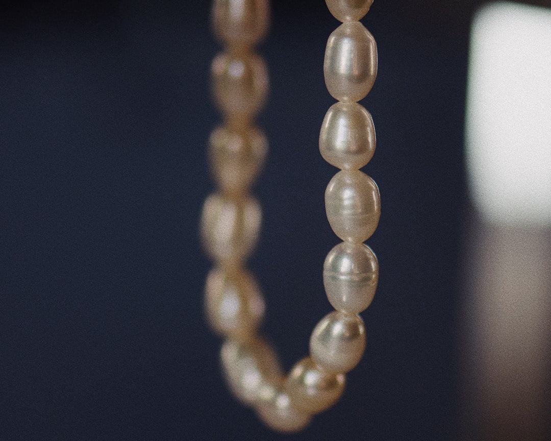 Artistic image of the Aqua – A natural freshwater pearls beaded necklace on navy background